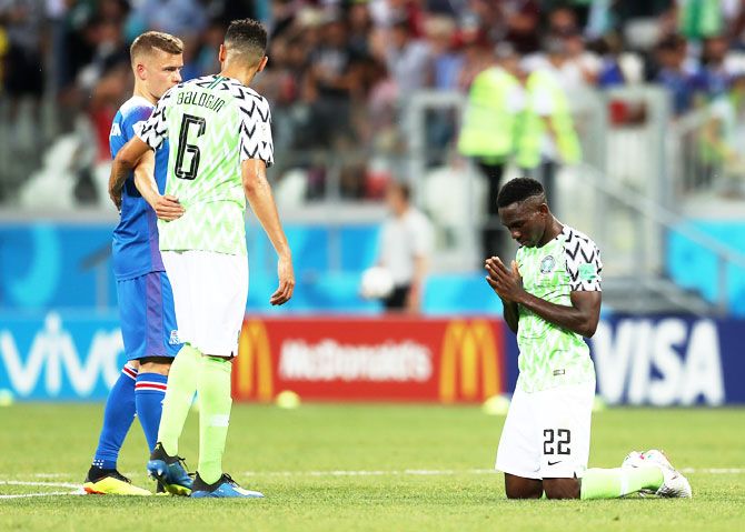 Nigeria's Kenneth Omeruo sinks to his knees and prays as he celebrates following his side's victory over Iceland in their Group D match