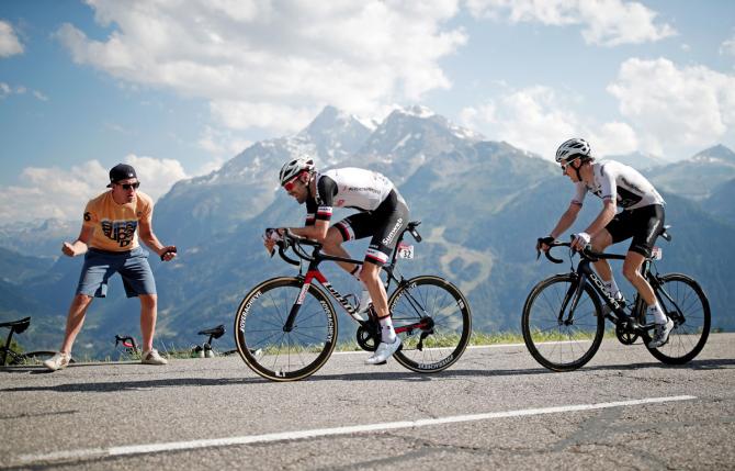 Team Sunweb's Tom Dumoulin of the Netherlands and Team Sky rider Geraint Thomas of Britain in action on the final climb of the 108.5-km Stage 11 from Albertville to La Rosiere Espace San Bernardo as a fan spurs them on on July 18