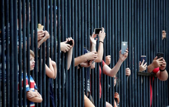 Fans watch the final stage of the Tour de France on Sunday