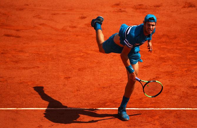 Russia's Karen Khachanov serves against Alexander Zverev