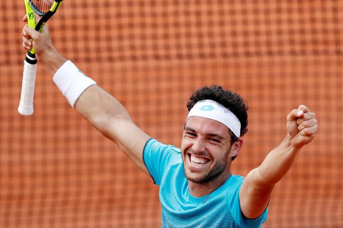 Italy's Marco Cecchinato celebrates winning his fourth round match against Belgium's David Goffin