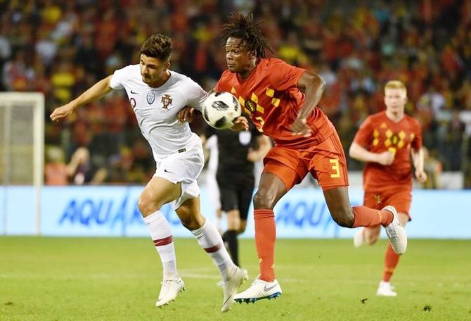 Portugal's Andre Silva and Belgium's Dedryck Boyata battle for possession