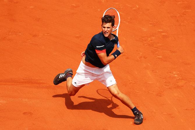 Austria's Dominic Thiem plays a forehand during his fourth round match against Japan's Kei Nishikori