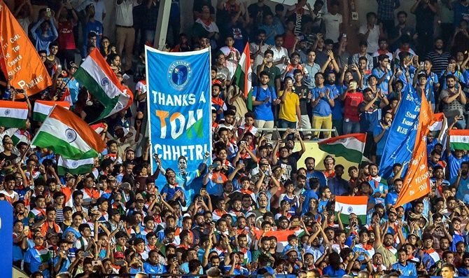 Indian football fans cheer on the team