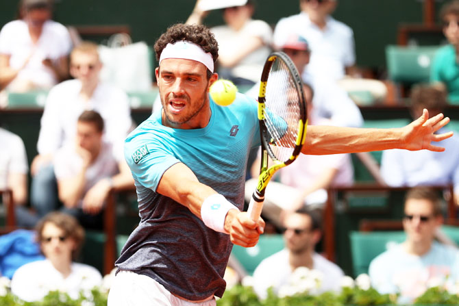 Italy's Marco Cecchinato plays a backhand return during his men's semi-final match against Austria's Dominic Thiem 