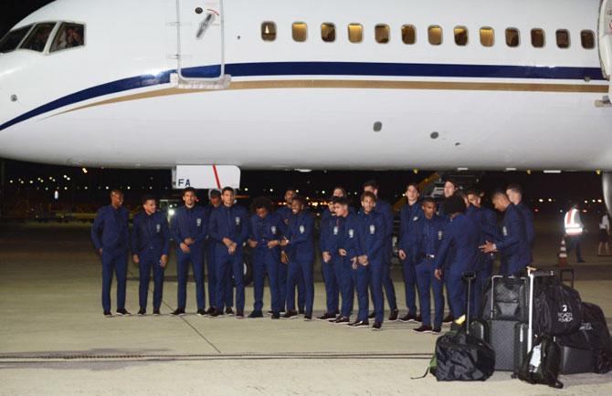 Brazil's players pose near a plane upon the arrival at the Sochi International Airport, Sochi, Russia, on Monday