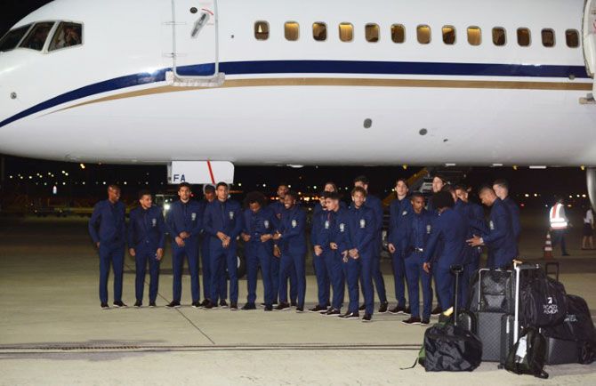 Brazil's players pose near a plane upon the arrival at the Sochi International Airport, Sochi, Russia, on Monday