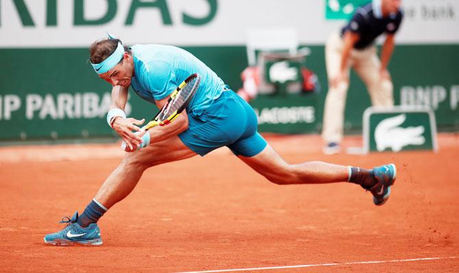 Austria's Dominic Thiem hits the ball long for Spain's Rafael Nadal to win the final