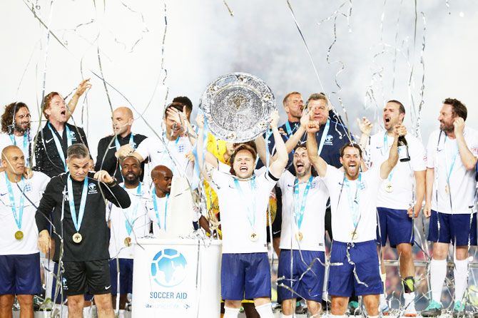 Olly Murs of England lifts the trophy with teammates after the Soccer Aid for UNICEF 2018 match