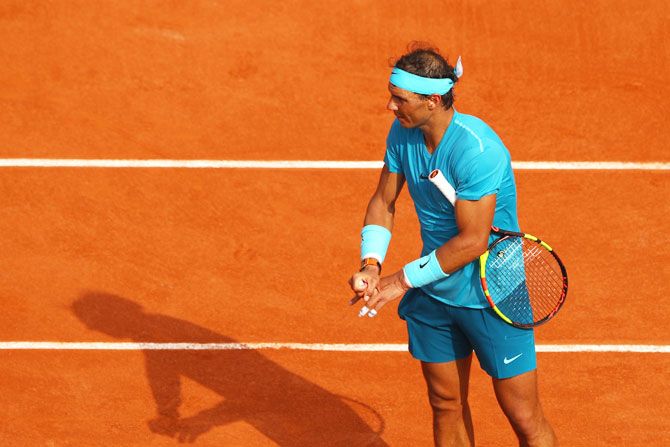 Rafael Nadal stretches his fingers following an injury during the French Open final