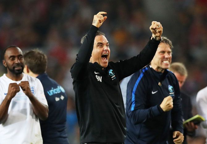 Singer Robbie Williams of England celebrates a successful penalty in the shoot out during the Soccer Aid for UNICEF 2018 match