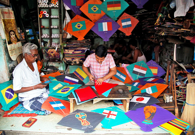 Kite-makers make kites with pictures of the national flags of the countries participating in the upcoming FIFA World Cup in Russia, at a workshop in Kolkata on June 5