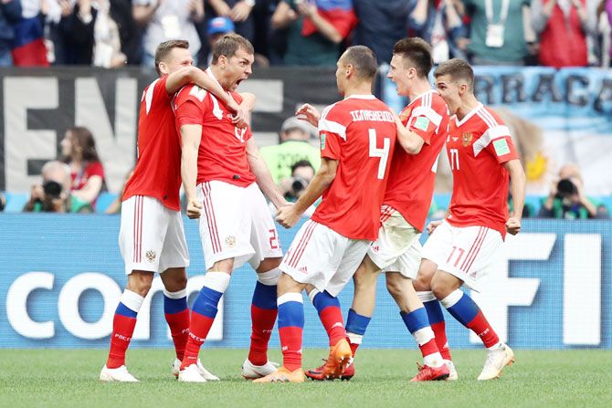 Russia's Artem Dzyuba celebrates with teammates after scoring the third goal just after coming off the bench