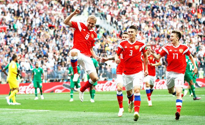 Russia's Yury Gazinsky celebrates with teammates after scoring their first goal against Saudi Arabia on Thursday