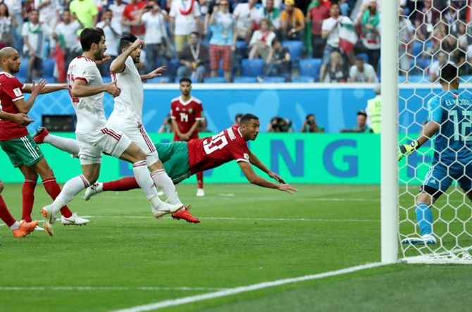 Aziz Bouhaddouz of Morocco scores an own goal against Iran