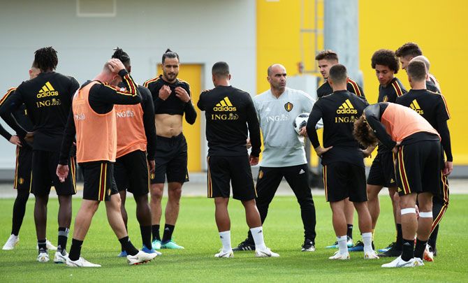 Belgium coach Roberto Martinez with their players during training 