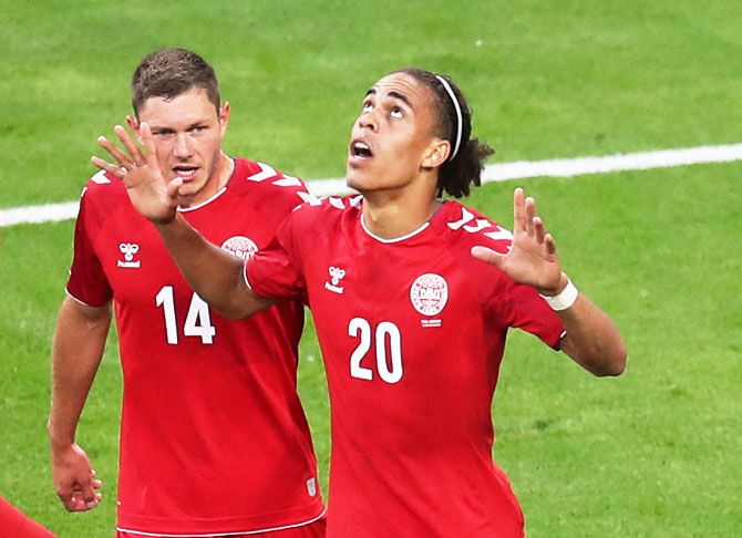 Denmark's Yussuf Poulsen celebrates with teammate Henrik Dalsgaard after scoring their first goal against Peru on Saturday