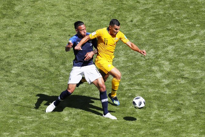 France's Corentin Tolisso and Australia's Andrew Nabbout battle for the ball