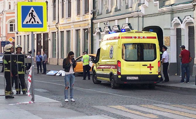 A damaged taxi, which ran into a crowd of people, is evacuated in central Moscow on Saturday