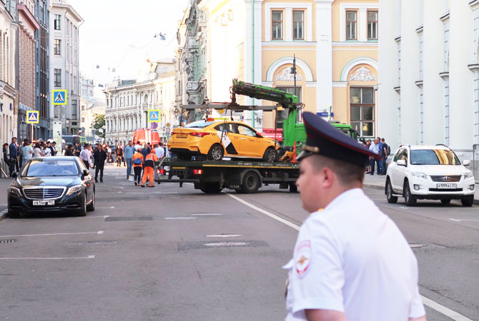 A damaged taxi, which ran into a crowd of people, is evacuated in central Moscow,