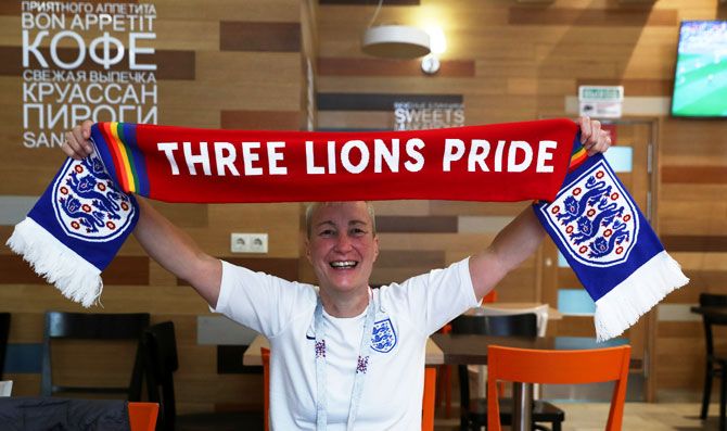 England football fan and LGBT rights campaigner Di Cunningham displays a scarf during an interview with Reuters in Volgograd, Russia, on Monday
