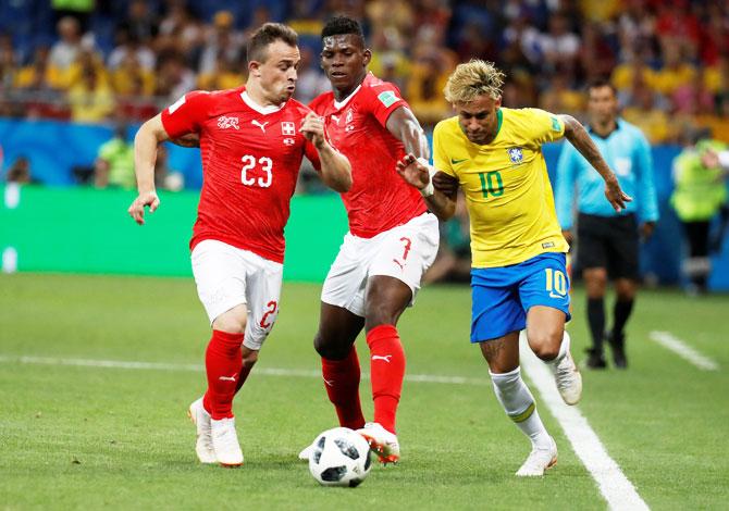 Brazil's Neymar is challenged by Switzerland's Xherdan Shaqiri and Breel Embolo