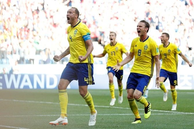 Sweden's Andreas Granqvist celebrates with Albin Ekdal and team mates after scoring.