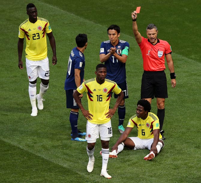 Carlos Sanchez of Colombia, right, is sent off by referee Damir Skomina during the match against Japan