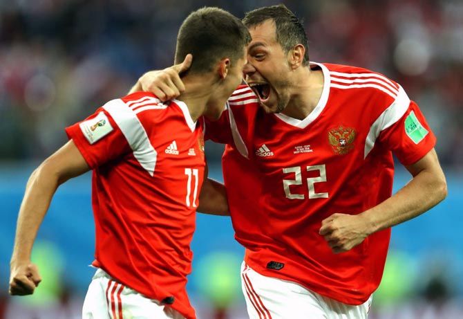 Artem Dzyuba and Roman Zobnin celebrate as Russia go one up from an own goal by Egypt’s Ahmed Fathi, in the World Cup Group A match