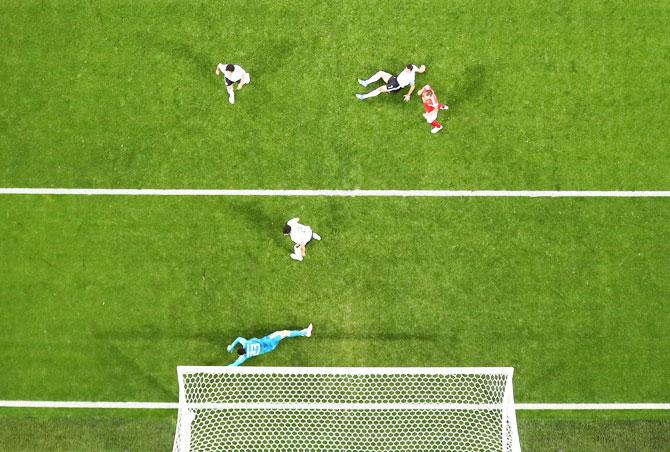 Egypt's Ahmed Fathi scores an own goal past keeper Mohamed Elshenawy to help score Russia's first goal during their Group A match at Saint Petersburg Stadium in Saint Petersburg on Tuesday