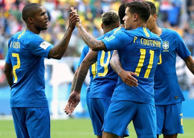 Brazil's players celebrate a goal with Philippe Coutinho 