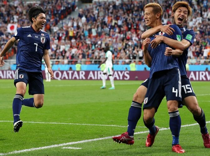 Keisuke Honda of Japan celebrates with teammate Yuya Osako after scoring his team's second goal against Senegal in their Group H match