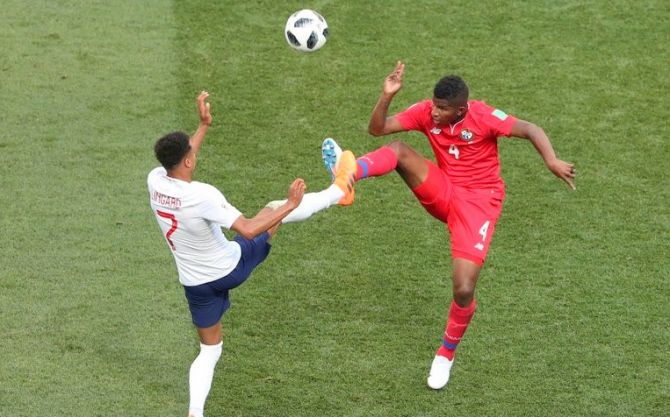 Panama's Fidel Escobar and with England's Marcus Rashford vie for possession 