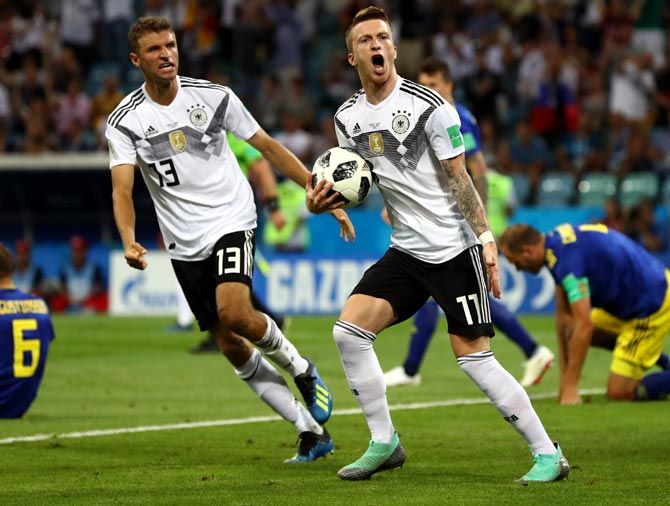 Marco Reus, right, celebrates with Thomas Mueller after scoring Germany's first goal against Sweden. Photograph: Dean Mouhtaropoulos/Getty Images