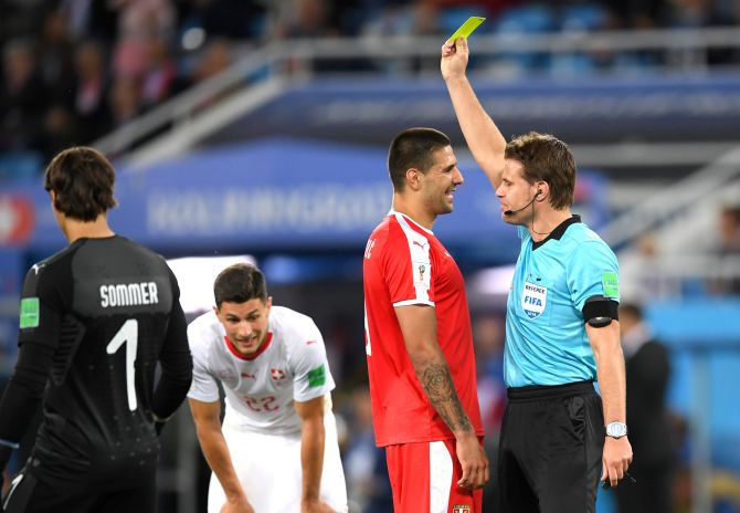 Serbia's Aleksandar Mitrovic is shown a yellow card by referee Felix Brych during the 2018 FIFA World Cup Group E match against Switzerland at Kaliningrad Stadium on Friday