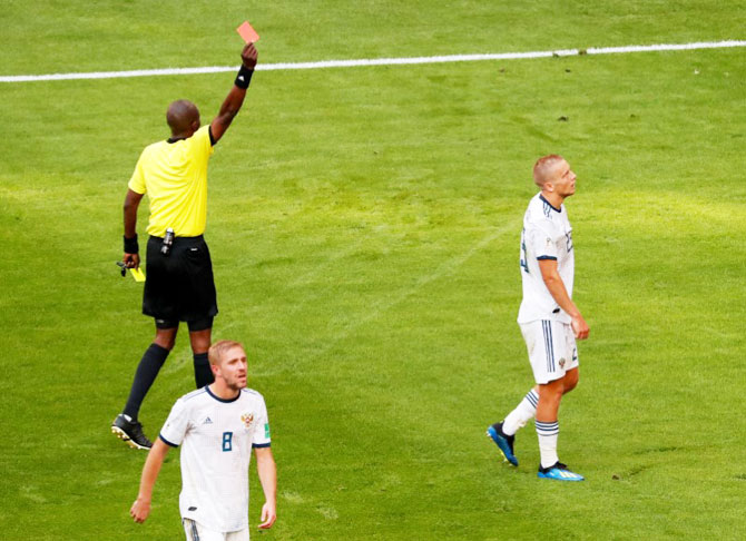 Russia's Igor Smolnikov is shown a second yellow and a subsequent red card by referee Malang Diedhiou