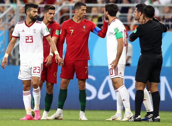Cristiano Ronaldo argues with referee Enrique Caceres. Photograph: Jan Kruger/Getty Images