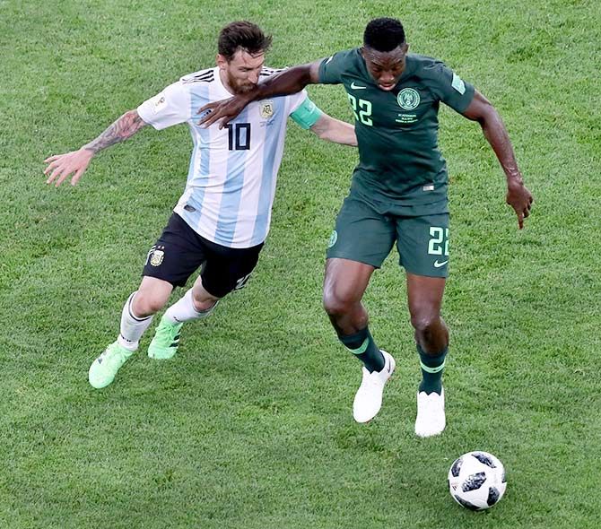 Argentina's Lionel Messi and Nigeria' Kenneth Omeruo vie for possession