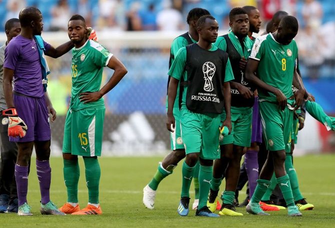 Khadim Ndiaye of Senegal consoles teammate Diafra Sakho following their sides defeat