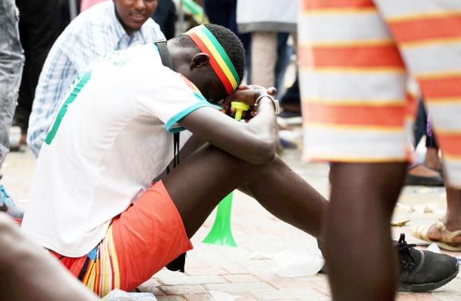 A Sengalese fan reacts after the match against Colombia in Dakar on Thursday