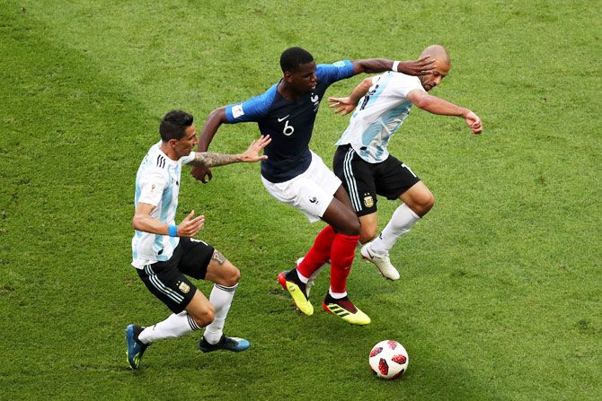 France's Paul Pogba is challenged by Argentina's Javier Mascherano and Angel Di Maria
