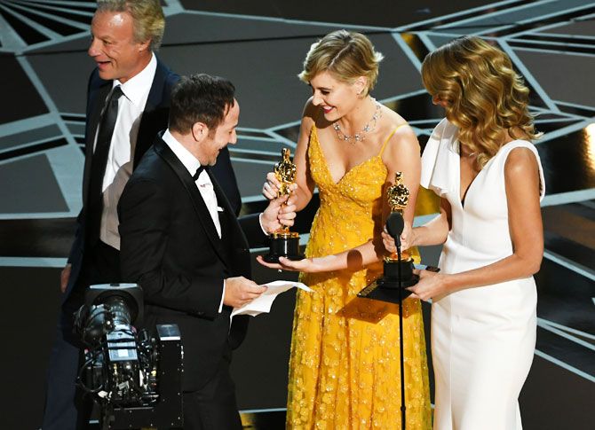 (Left to Right): Producer David Fialkow and director Bryan Fogel accept Best Documentary Feature for 'Icarus' from actor/director Greta Gerwig and actor Laura Dern onstage during the 90th Annual Academy Awards at the Dolby Theatre at Hollywood & Highland Center in Hollywood, California, on Sunday