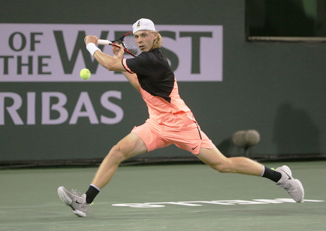 Canada's Denis Shapovalov lunges to play a backhand return to Lithuania's Ricardas Berankis