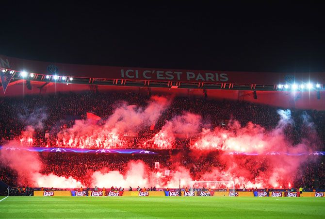 PSG fans light flares during the UEFA Champions League Round of 16 Second Leg match between Paris Saint-Germain and Real Madrid at Parc des Princes in Paris on Tuesday