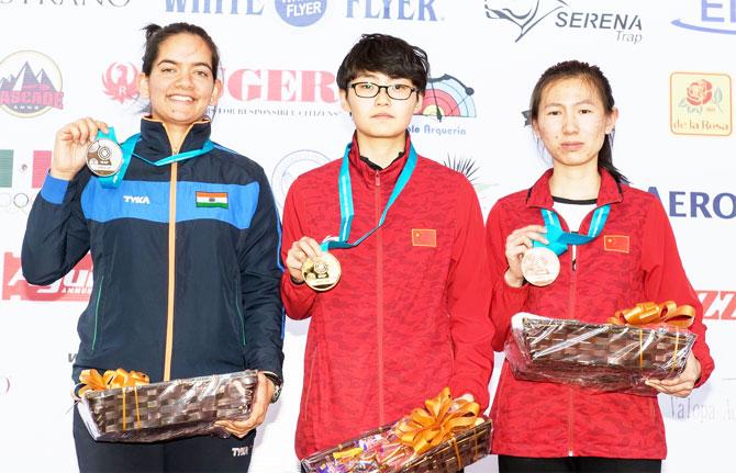 India's Anjum Moudgil (left) battled windy conditions to shoot 454.2 in the 45-shot final to finish behind former junior world champion China’s Ruijiao Pei, centre, while Ting Sun, another Chinese, claimed bronze.