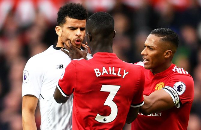 Manchester United's Eric Bailly clahses with Liverpool's Dominic Solanke