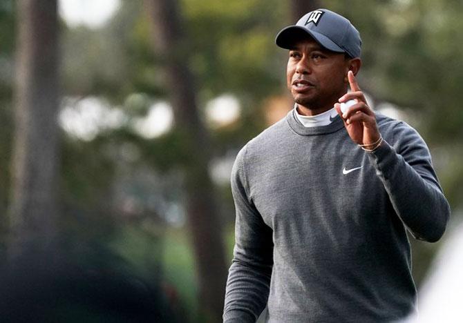 Tiger Woods waves after putting for par on the 16th during the first round of the Valspar Championship golf tournament at Innisbrook Resort, Copperhead Course in Palm Harbor, Florida, on Friday