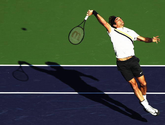 Switzerland's Roger Federer hits a smash during his match against Argentina's Federico Delbonis