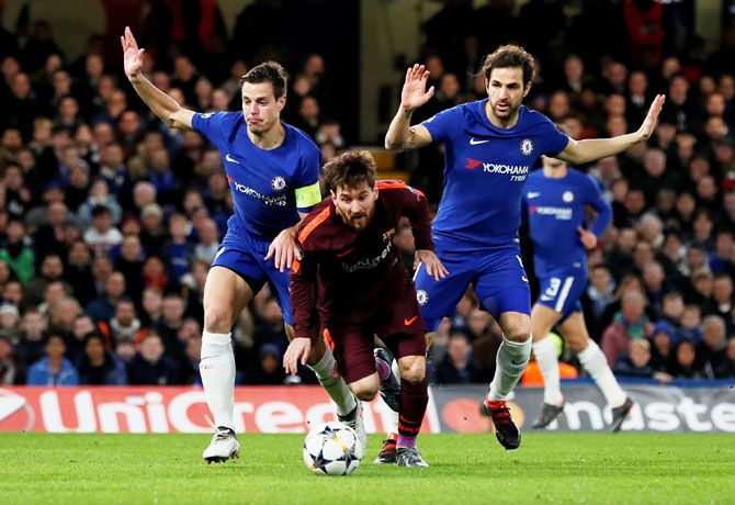 Barcelona’s Lionel Messi is put under pressure by Chelsea's Cesar Azpilicueta and Cesc Fabregas