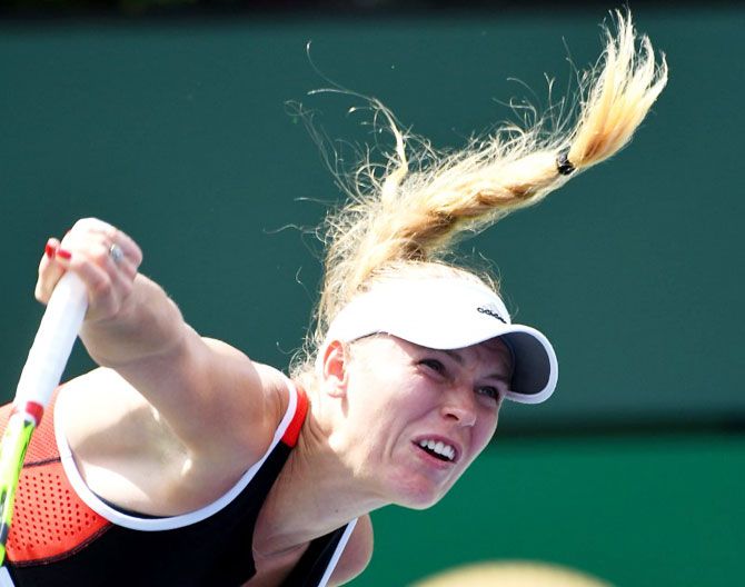 Denmark's Caroline Wozniacki serves during her third round match against Belarusian Aliaksandra Sasnovich
